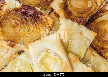 Open pies from puff pastry with cheese, bacon, onion. Mini pizza. Selective focus Stock Photo
