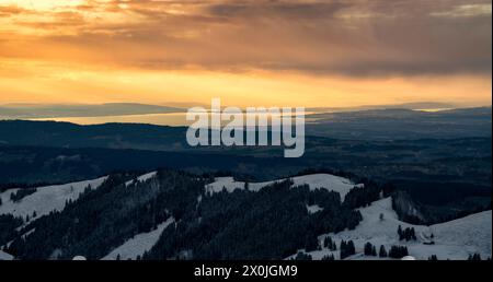 Colorful sunset over Lake Constance. View from the Allgäu Alps over the Alpine foothills to the west. Swiss shore on the left, Upper Swabia on the right. Bavaria, Germany. Stock Photo