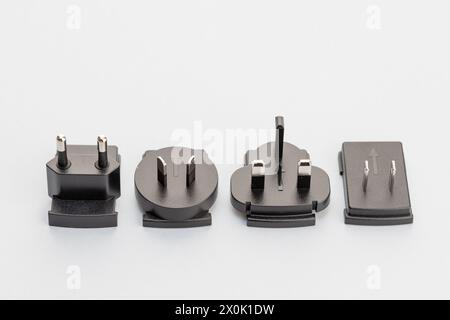 Variety of electrical plugs from different regions worldwide isolated on gray background Stock Photo