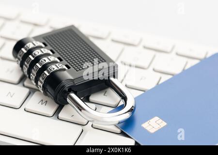 Padlock and credit card on computer keyboard. E-commerce internet and finance security concept Stock Photo