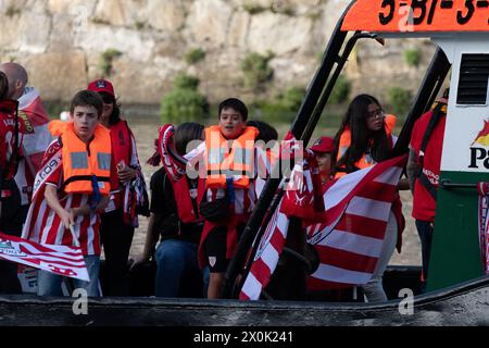 Bilbao, Biscay, Spain - April 11th 2024 - Athletic Club de Bilbao fans celebrate the 25th Copa del Rey title with the barge Stock Photo