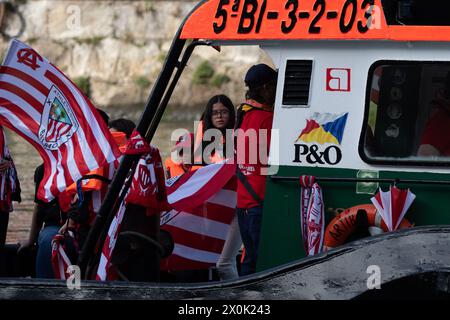 Bilbao, Biscay, Spain - April 11th 2024 - Athletic Club de Bilbao fans celebrate the 25th Copa del Rey title with the barge Stock Photo