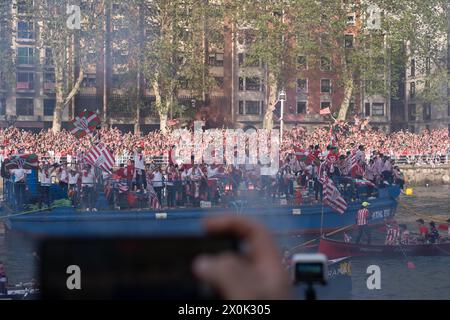 Bilbao, Biscay, Spain - April 11th 2024 - Athletic Club de Bilbao fans celebrate the 25th Copa del Rey title with the barge Stock Photo