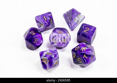 A purple set of role playing dice on a white background Stock Photo