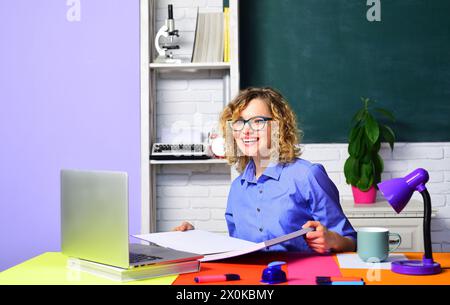Smiling teacher giving lecture at classroom. Female student studying in university or high school college. E-learning. Online webinar. Beautiful Stock Photo