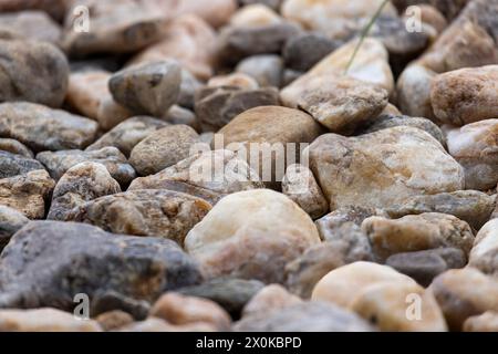 Picture on a floor consisting of different sized and colored stones in daylight Stock Photo