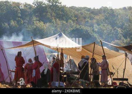 England, East Sussex, Battle, The Annual October Battle of Hastings Re-enactment Festival, The English Encampment with Event Participants dressed in Medieval Costume Stock Photo