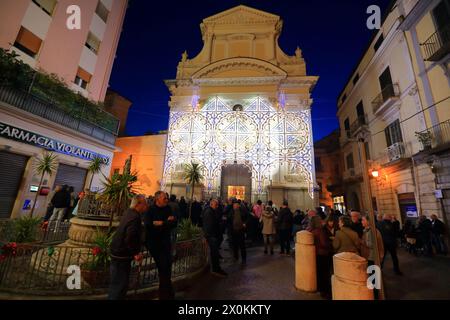 Sellers of tammorre , people around the toselli and the entrance of the Sanctuary of Madonna delle Galline in the evening before the procession. Stock Photo