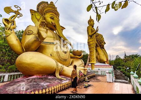Tourist in front of the huge golden Ganesha statue of the Buddhist temple Wat Mokkanlan in Chom Thong, Thailand, Asia Stock Photo