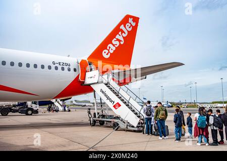 Passengers boarding an EasyJet aircraft via steps from the tarmac at the rear door at Birmingham International Airport Stock Photo