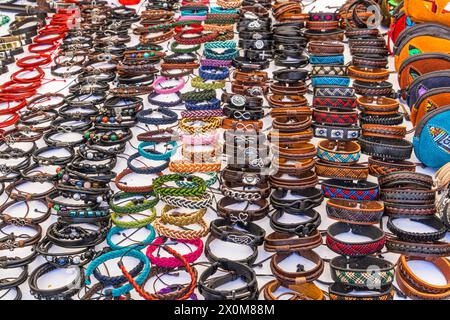 A large selection of colorful leather bracelets with beads, metal and other embellishments at a craft market in Cuenca, Ecuador. Selective focus. Stock Photo