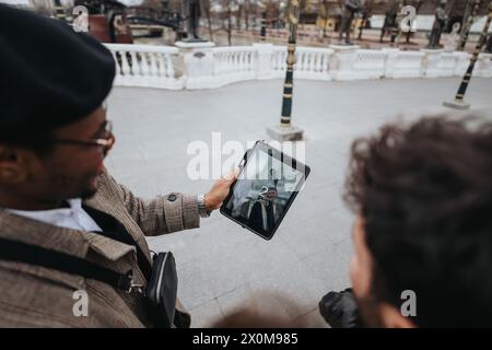 Two young business entrepreneurs engaging with a digital tablet in an urban city environment, embodying innovation and connectivity. Stock Photo