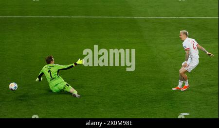 Augsburg, Germany. 12th Apr, 2024. Phillip Tietz (R) of Augsburg shoots to score during the German first division Bundesliga football match between FC Augsburg and Union Berlin in Augsburg, Germany, April 12, 2024. Credit: Philippe Ruiz/Xinhua/Alamy Live News Stock Photo