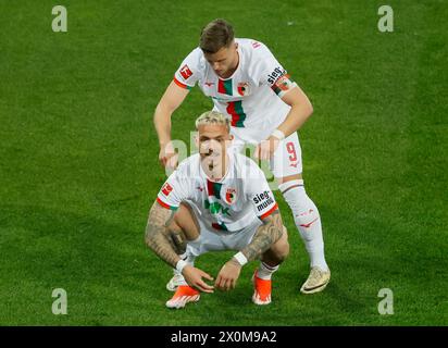 Augsburg, Germany. 12th Apr, 2024. Phillip Tietz (front) of Augsburg celebrates scoring with his teammate Ermedin Demirovic during the German first division Bundesliga football match between FC Augsburg and Union Berlin in Augsburg, Germany, April 12, 2024. Credit: Philippe Ruiz/Xinhua/Alamy Live News Stock Photo