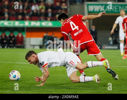 Augsburg, Germany. 12th Apr, 2024. Diogo Leite (R) of Union Berlin vies with Pep Biel Mas Jaume of Augsburg during the German first division Bundesliga football match between FC Augsburg and Union Berlin in Augsburg, Germany, April 12, 2024. Credit: Philippe Ruiz/Xinhua/Alamy Live News Stock Photo