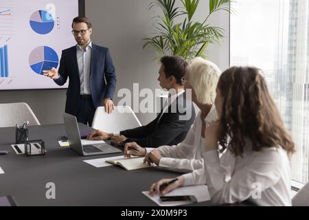Diverse group of professionals and CEO engaged in formal meeting Stock Photo