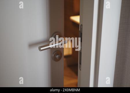 gray bathroom door slightly open . Stock Photo