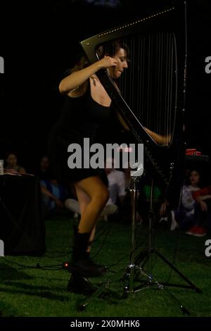 Mexico City, Mexico. 12th Apr, 2024. Kety Fusco, an Italian harpist, is performing at the Istituto Italiano di Cultura di Citta del Messico in Mexico City. She is using materials from which a classical harp is made--wood, metal, and gut--to produce and manipulate sounds with pedals, generating electronic and contemporary music with the harp. Fusco has collaborated with musicians such as Clap! Clap!, Lubomyr Melnyk, and the Peter Kernel band, among others. (Photo by Gerardo Vieyra/NurPhoto) Credit: NurPhoto SRL/Alamy Live News Stock Photo