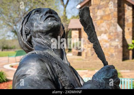 Statue of Cherokee Indian alphabet inventor, Sequoyah, looking upward with feather quill pen, at Sequoyah's Cabin Historic Site in Sallisaw, OK. (USA) Stock Photo