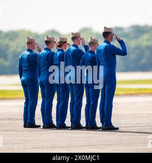 April 07, 2024: Officers of the U.S. Navy Flight Demonstration Squadron Blue Angels (L-R) #6 Commander Thomas Zimmerman, #5 Lieutenant Commander Griffin Stangel, #4 Lieutenant Commander Amanda Lee, #3 Lieutenant James Wesley Perkins, #2 Lieutenant Commander Jack Keilty and #1 Commander Alexander P. Armatas salute the flag after exiting their Boeing F/A-18 Super Hornet aircraft at the end of the aerobatic demonstration at the Beyond The Horizon Air and Space Show at Maxwell Air Force Base in Montgomery, Alabama. Mike Wulf/CSM Stock Photo