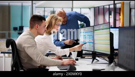 Analyst Employee Working On Spreadsheet Using Desktop Computer Stock Photo