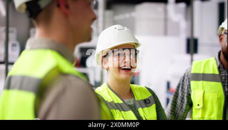 Factory Engineer Team Talking At Industrial Manufacturing Plant Stock Photo