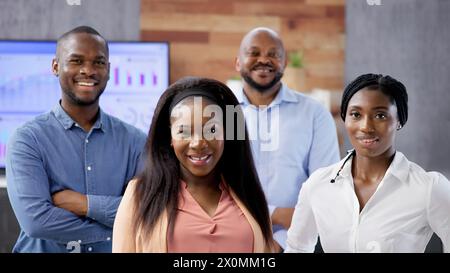 A diverse group of business professionals stand together in a circle ...