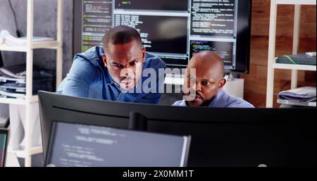 Working Business Team of African Code Developers on Computers Stock Photo