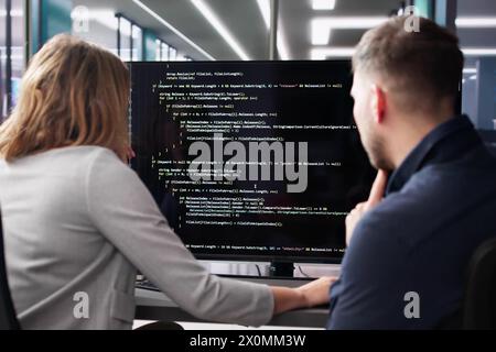 Agile software developer using computer at desk Stock Photo