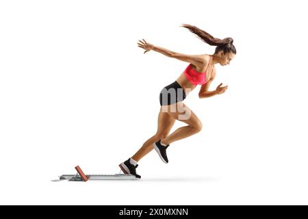 Female runner starting a race from a starting block isolated on white background Stock Photo