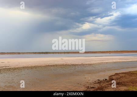 Dark storm clouds over a salt lake before a rain Stock Photo