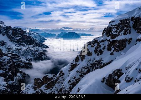 Aerial view of the Auronzo valley and snow-covered alpine Dolomite landscape in winter, seen from Rifugio Auronzo in Tre Cime Natural Park. Stock Photo
