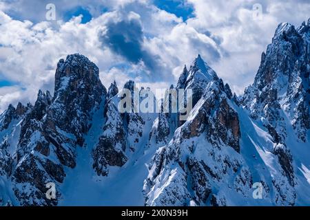 Snow-covered alpine Dolomite landscape in winter with the summits Torre Siorpaes (left) and Cimon di Croda Liscia (right), seen from Monte Campedele. Stock Photo