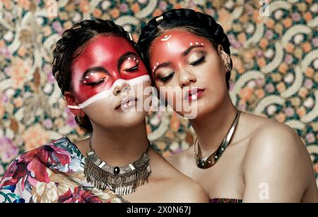 Tribal, makeup and culture of Native American Indian women with pride in beauty, face paint and jewelry. Traditional, models and indigenous costume of Stock Photo