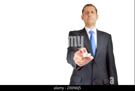 Young hispanic man with suit holding television remote control against a white background Stock Photo