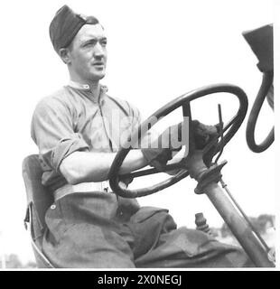 PHOTOGRAPHS TAKEN TO ILLUSTRATE OBSERVER STORIES BY CAPT. SHEARER - L/Cpl. Daniels of Leighton Road,Kentish Town, London, N.W.5 seated at the wheel of his tractor. (Observer Story No. 94). Photographic negative , British Army Stock Photo