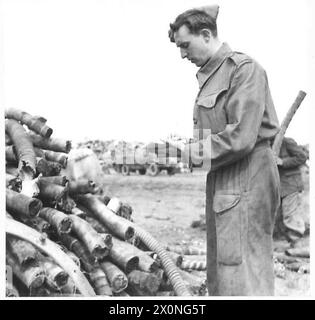 PHOTOGRAPHS TAKEN TO ILLUSTRATE OBSERVER STORIES BY CAPT. SHEARER - Pte. C. Young of 71 Howthorne Avenue, Yeadon, near Leeds, Yorks checking over salvage at the Salvage Dump. (Observer Story No.95). Photographic negative , British Army Stock Photo