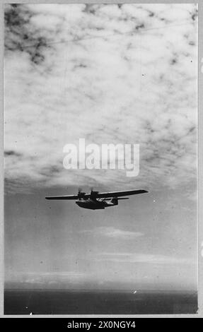 BRITISH OVERSEAS AIRWAYS AT WAR - For story see CH.14892 Picture (issued 1945) shows - A Catalina flyingboat of Qantas in flight off the coast of Ceylon. Photographic negative , Royal Air Force Stock Photo