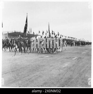KING IBN SAUD SEES EGYPT'S MILITARY MIGHT - With pennants flying, Egyptian mounted troops pass the royal dais during the colourful March Past Stock Photo