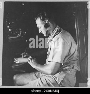 BRITISH OVERSEAS AIRWAYS AT WAR - For story see CH.14892 Picture (issued 1945) shows - The radio officer at work during flight in a Qantas Catalina flyingboat. Photographic negative , Royal Air Force Stock Photo