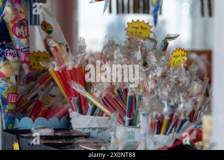 Brightly coloured sticks of rock for sale, traditional sight around British seaside and tourist resorts. Stock Photo