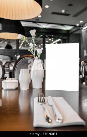 Served table in restaurant with blank mockup menu for advertising text and design Stock Photo