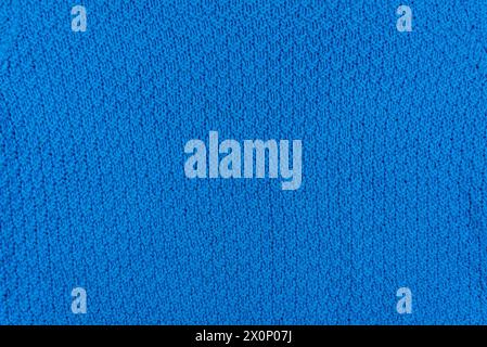 Texture and pattern of a knitted blue wool sweater. Background of warm handmade wool fabric. Stock Photo