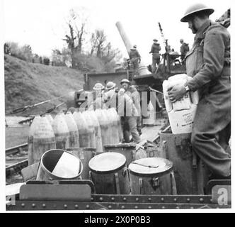 Cordite charges are removed from papier-mâché containers for disposal ...