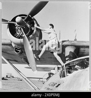 BRITISH OVERSEAS AIRWAYS AT WAR - For story see CH.14892 Picture (issued 1945) shows - The flight engineer at work on a Qantas Catalina flyingboat ar her moorings at Karachi. Photographic negative , Royal Air Force Stock Photo