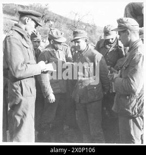 ITALY : EIGHTH ARMYRIVER SANGRO BATTLE - After the initial attack by the New Zealand Division, the German prisoners began to come into our lines. Some of the first batch of 33 are here seen being interrogated by the Divisional Intelligence Officer, Capt. Castello. Some of these prisoners fought in Russia and had their Russian campaign ribbon on their tunics. This batch was captured by men of the 6th N.Z. Inf. Bde. whose own casualties were very light. Photographic negative , British Army Stock Photo