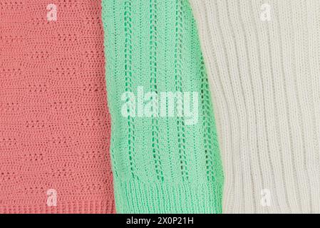 Background of texture and ornament of knitted wool sweaters of different colors Stock Photo