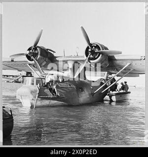BRITISH OVERSEAS AIRWAYS AT WAR - For story see CH.14892 Picture (issued 1945) shows - Passengers embarking at Karachi in the Qantas Catalina flyingboat 'ALTAIR' for the flight to Ceylon. Photographic negative , Royal Air Force Stock Photo