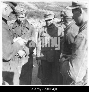 ITALY : EIGHTH ARMYRIVER SANGRO BATTLE - After the initial attack by the New Zealand Division, the German prisoners began to come into our lines. Some of the first batch of 33 are here seen being interrogated by the Divisional Intelligence Officer, Capt. Castello. Some of these prisoners fought in Russia and had their Russian campaign ribbon on their tunics. This batch was captured by men of the 6th N.Z. Inf. Bde. whose own casualties were very light. Photographic negative , British Army Stock Photo
