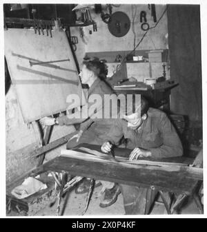 FIFTH ARMY : SPOTTING THE ENEMY GUNS - Gnr. A.W. Marzetti (right) of Ilford, Essex, reading the film and calling out the results to Gnr. H.C. Wanstall of Epsom, who is doing the plotting. Photographic negative , British Army Stock Photo